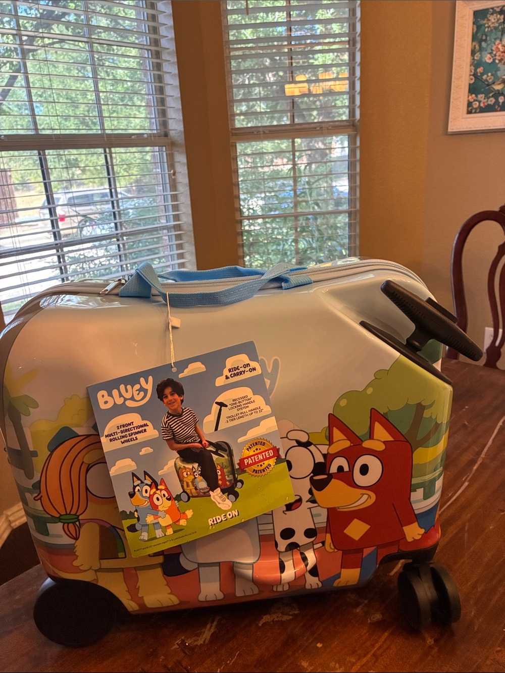 Lucy Light Blue Ride-On Kids Suitcase with Colorful Cartoon Graphics